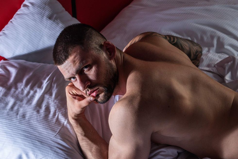 \u200bA man lying on a bed.