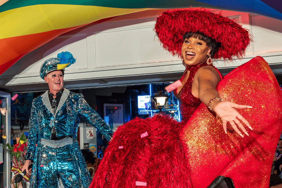 \u200bA performer in a dazzling red ensemble takes the stage during Key West's If the Shoe Fits competition.