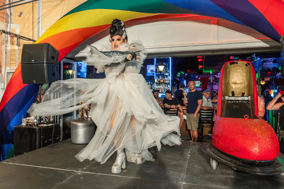 \u200bA performer showcases an elaborate white ensemble during the If the Shoe Fits competition.