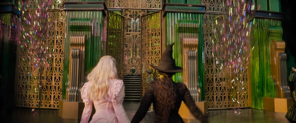 \u200bAriana Grande and Cynthia Erivo in front of the Wizard of Oz's palace in the Emerald City in the Wicked movie