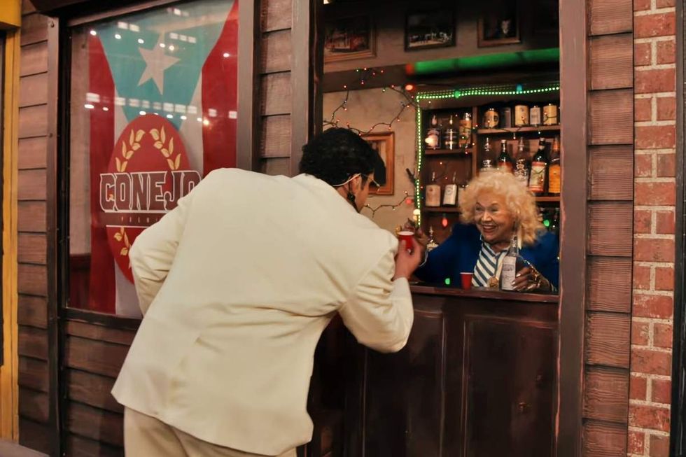 \u200bBad Bunny is served a drink by To\u00f1ita during the 2026 Super Bowl Halftime Show