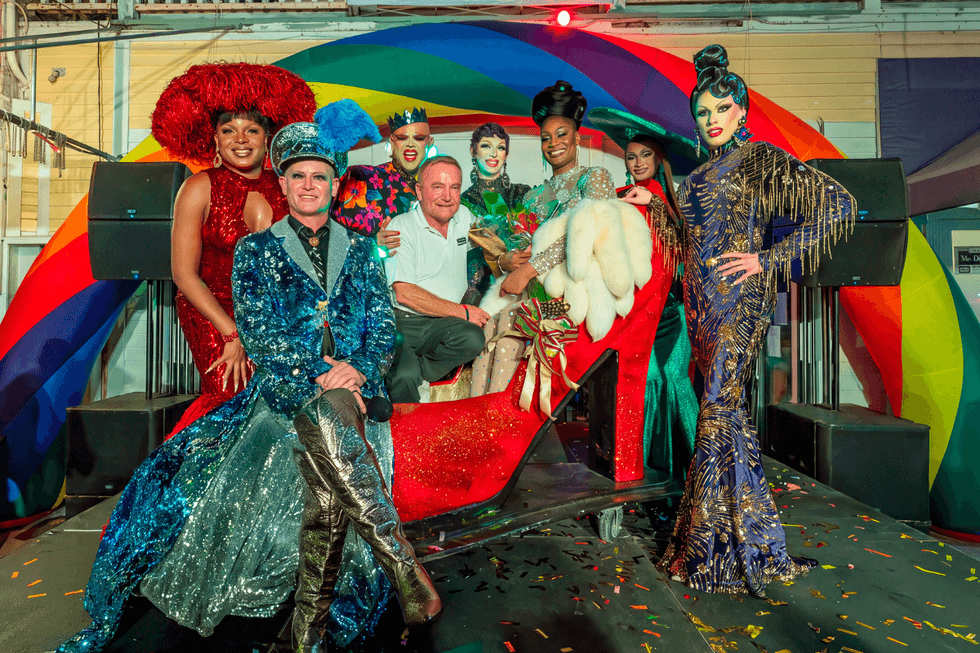 \u200bContestants and event participants gather around Key West's signature giant red high heel at the 2026 If the Shoe Fitsnational finals.
