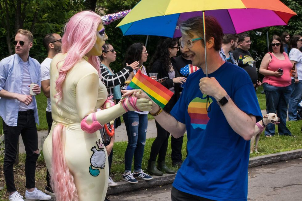 \u200bDrag queen high-fiving a man at Buffalo Pride.