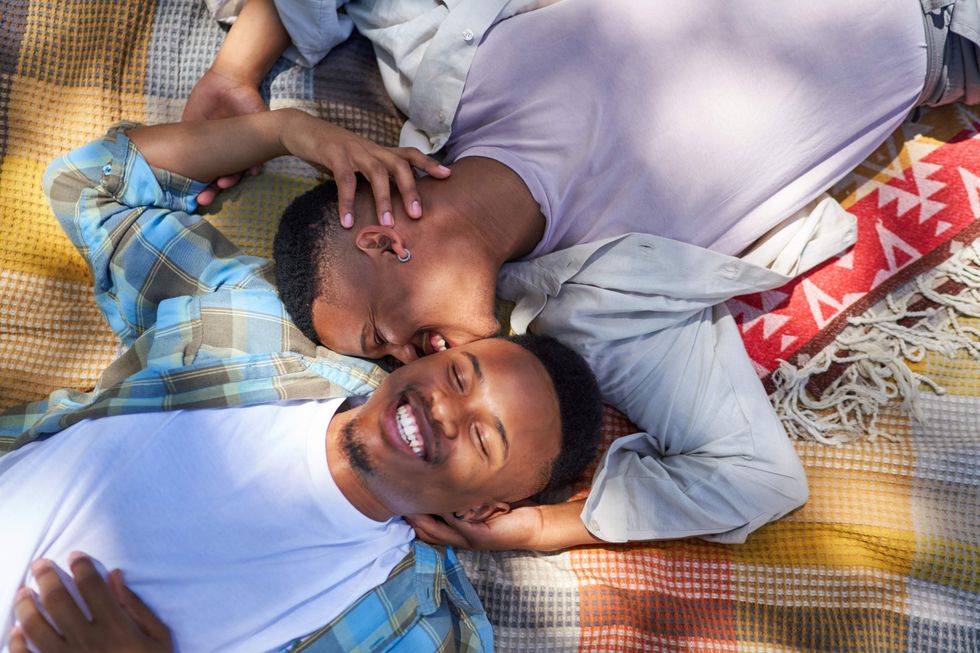 \u200bGay men lying on a blanket.