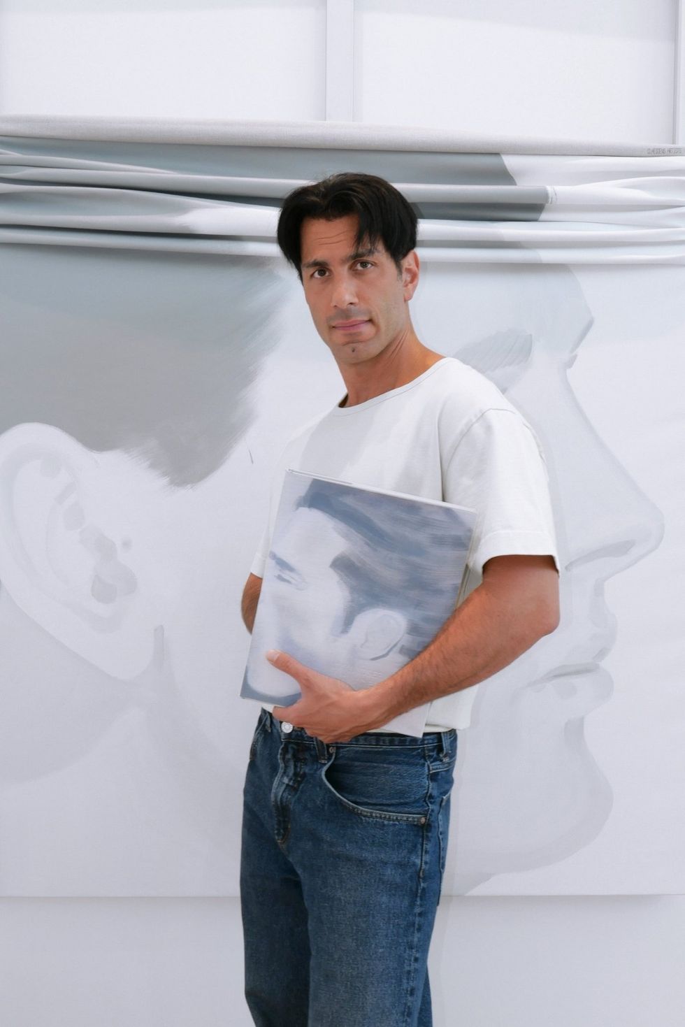 \u200bJwan Yosef poses for a photograph holding his book Intimacies