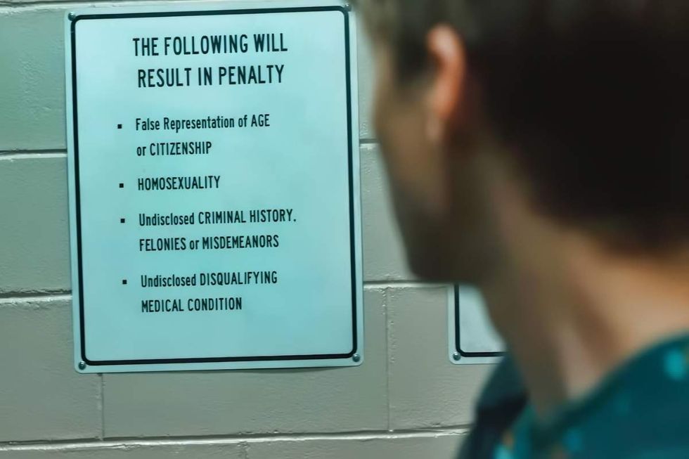 \u200bMiles Heizer as Cameron Cope reads a sign that lists homosexuality as something that would result in a penalty, as seen on \u200bBoots\u200b