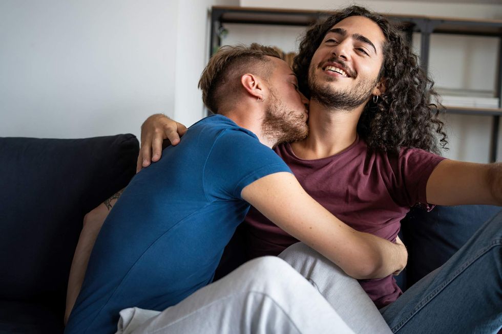 \u200bTwo gay men cuddling on a couch