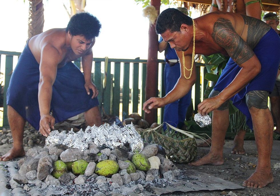 Upolu Samoa umu cooking where food is covered with hot stones and coconut frond mats