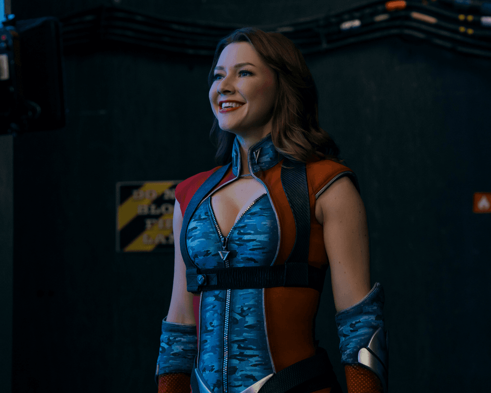 Valorie Curry smiles while dressed as Firecracker in a scene from The Boys