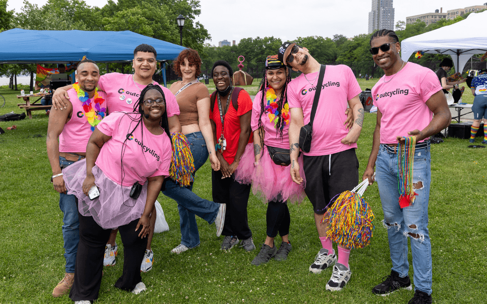 Volunteers and participants pose during Pride Ride festivities