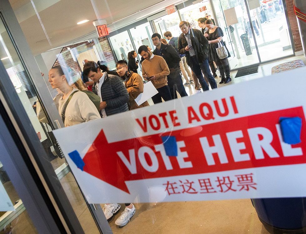 Voters stand in line at a local polling station in Washington DC