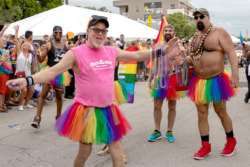 Wilton Manors Florida men in rainbow skirts and beads at pride parade