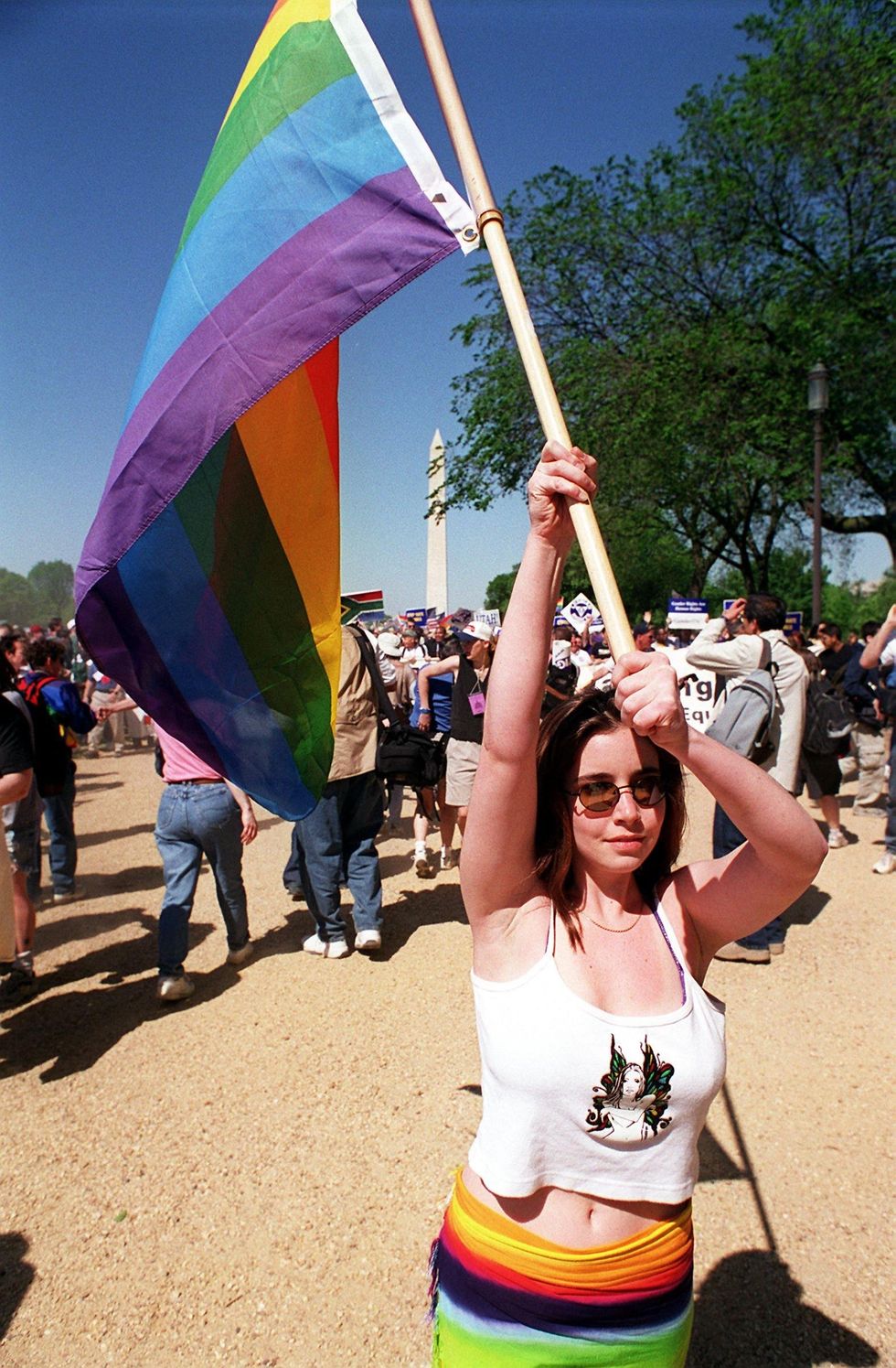 woman holding rainbow flag pride