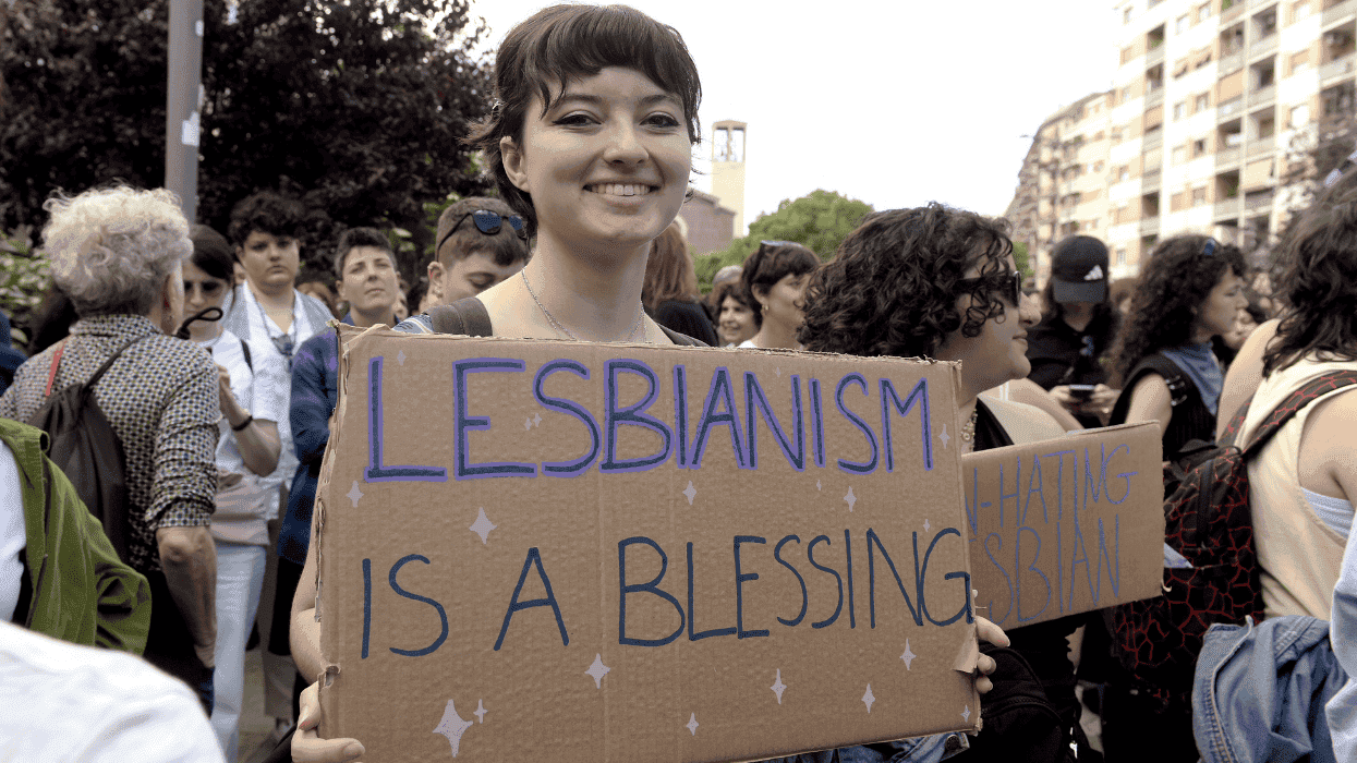 Woman with a lesbian sign.