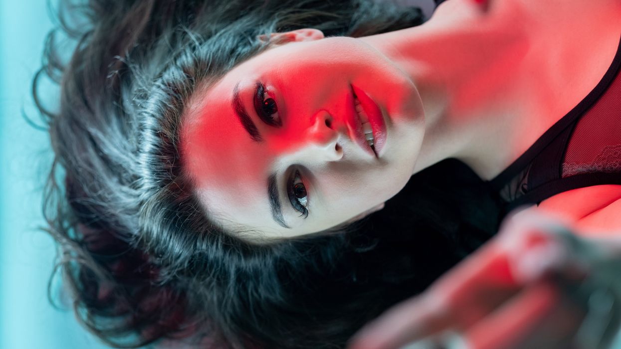 Woman with a red light glowing on her face