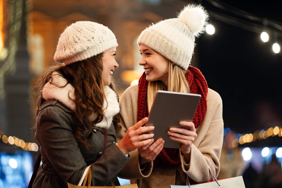 Women friends enjoy the night in shopping at Christmas. Sale, people digital tablet concept