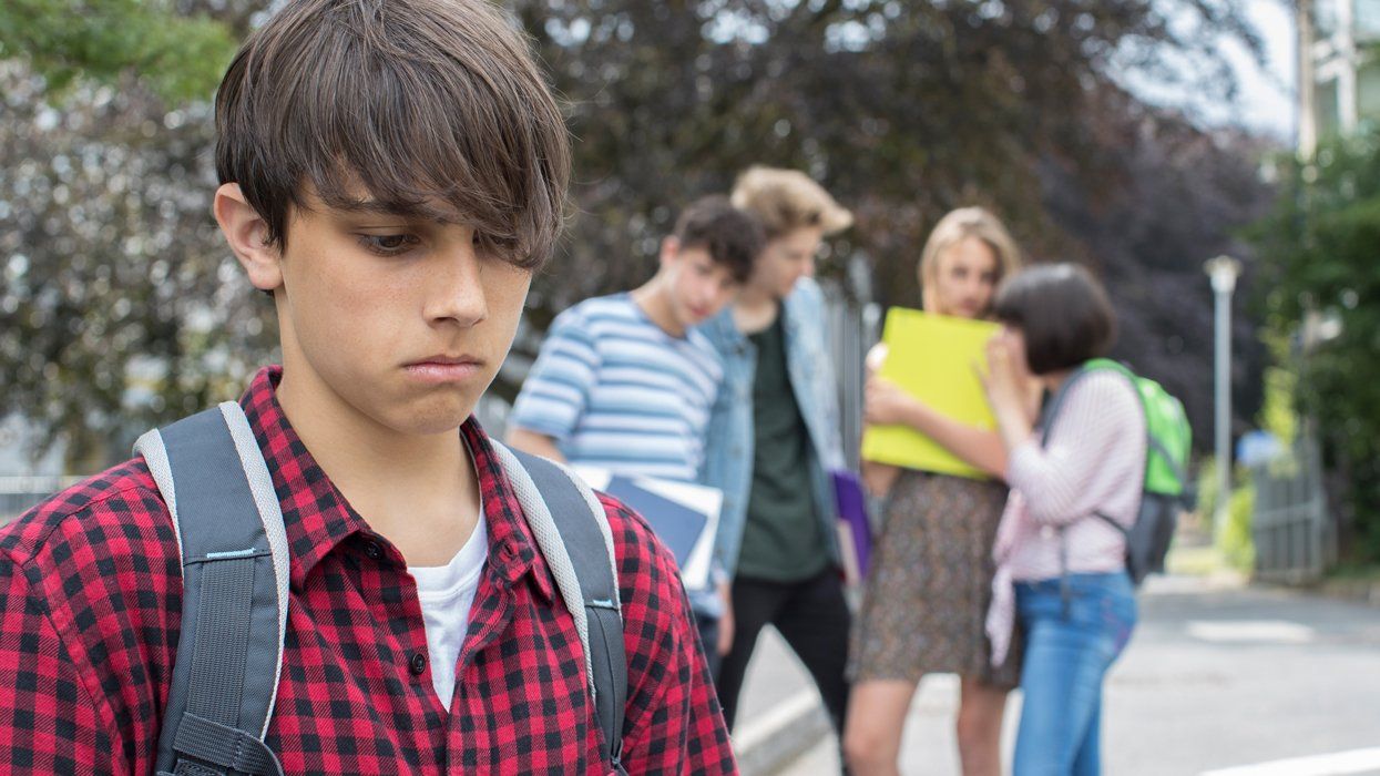 young teenage boy being bullied at school