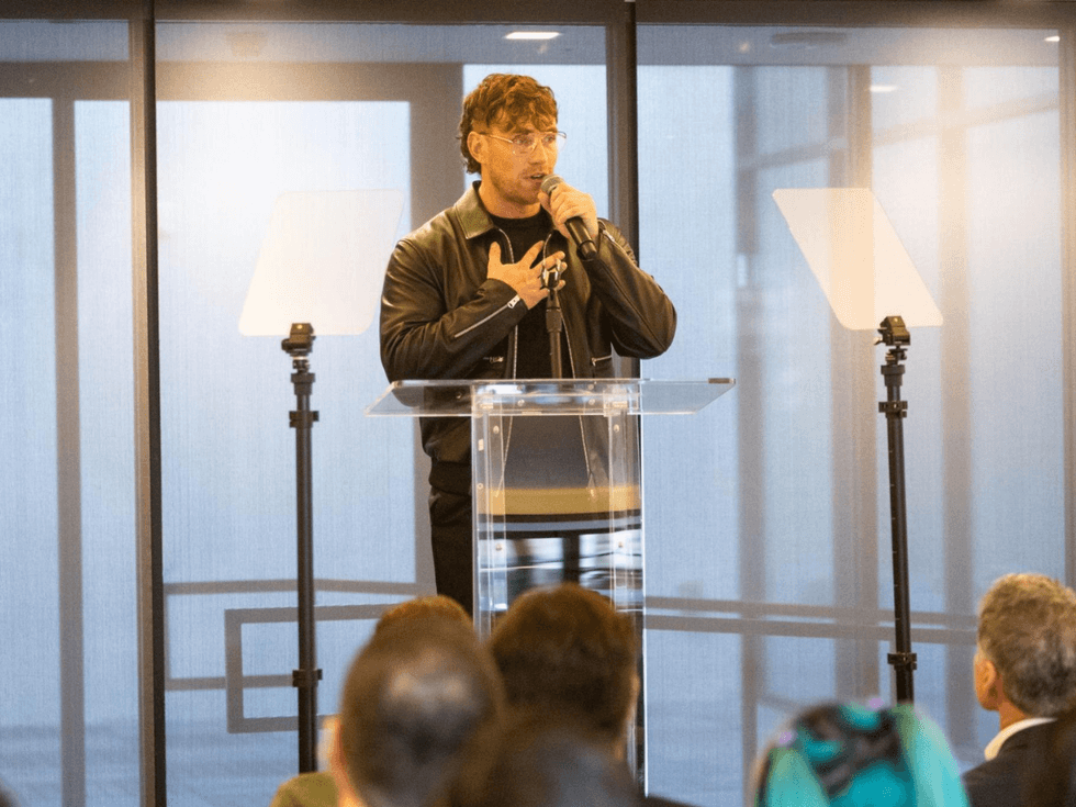Zane Phillips at a podium speaking at the Point Foundation graduation