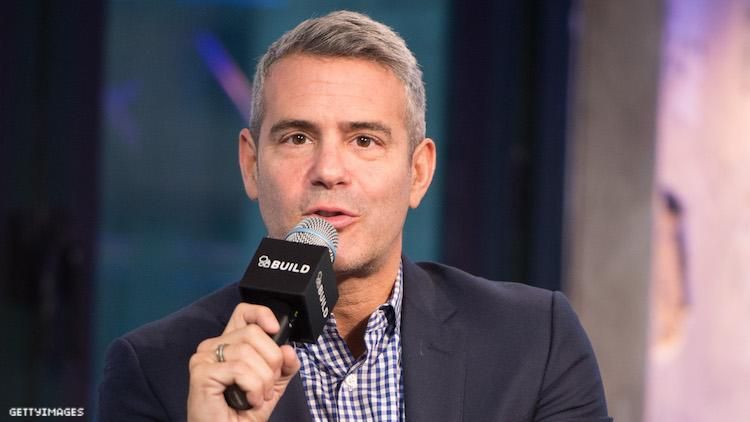 Andy Cohen speaking on a mic. 