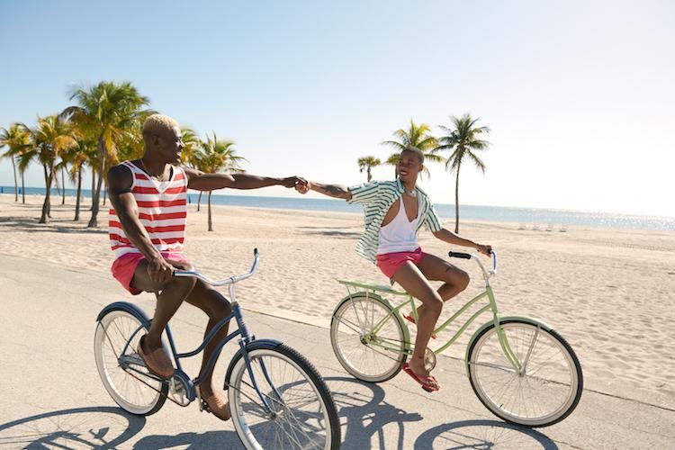 a Black gay couple riding bikes