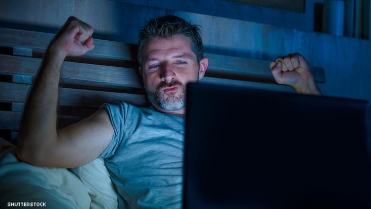 Guy watching computer screen while in the dark.