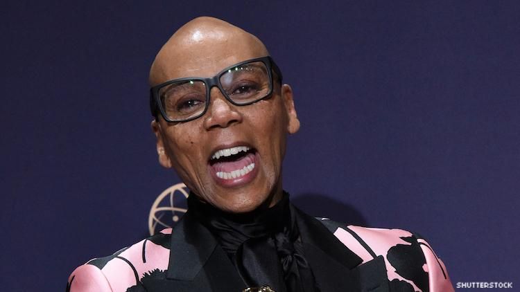 RuPaul on a red carpet with an Emmy.