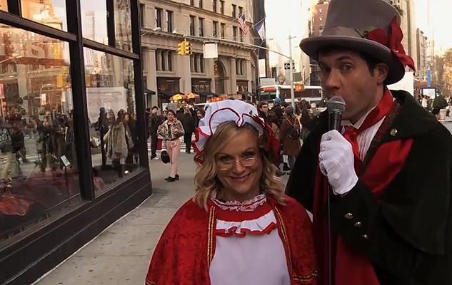 WATCH: Billy Eichner and Amy Poehler Sing Carols With Strangers
