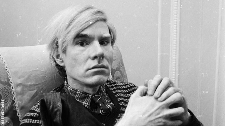 Andy Warhol sits for a portrait.