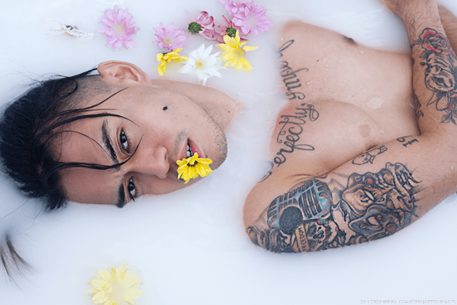 Sexy Philippines man in a tub of milk 