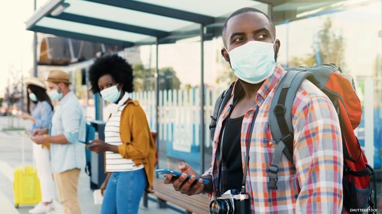 Black travelers wearing masks and social distancing