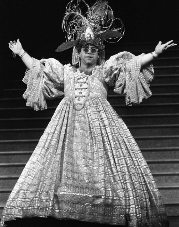 Elton John looks absolutely stunning on stage in the flowing gown.