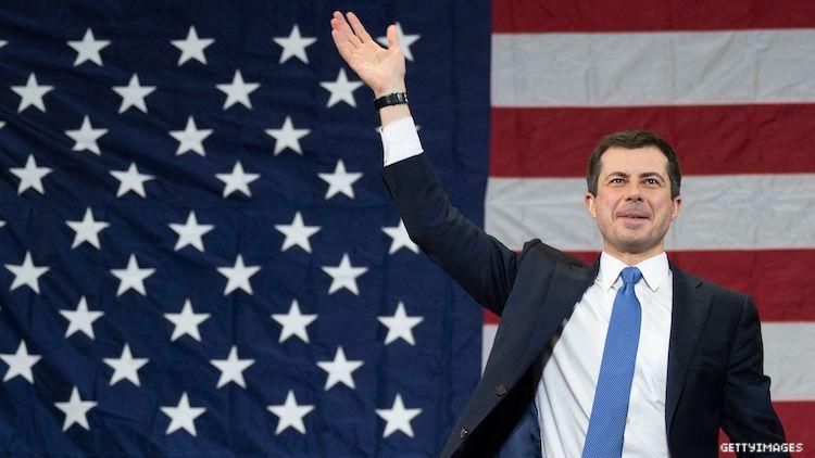 Pete Buttigieg in front of American flag
