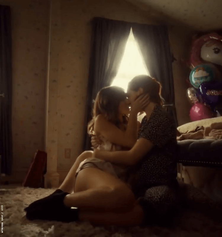 waverly and nicole kissing on a bed