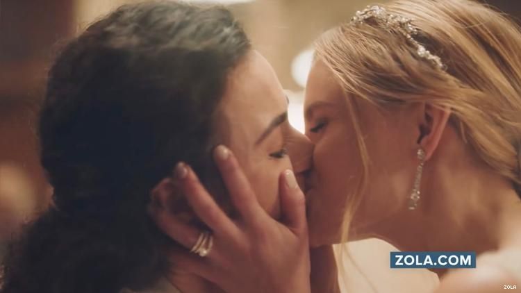 Two women kissing in Zola ad.